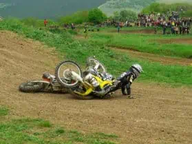 A dirt bike falls with a rider falls