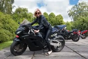 young lady rider posing while on the motorcycle