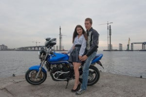 21 Year Old Couple Posting In front of A Bike