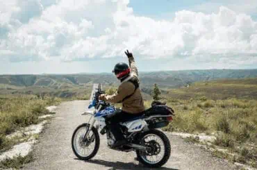 6 Best Ways Young Drivers Can Save on Motorcycle Insurance happy biker outdoor