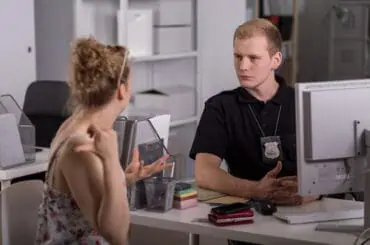 Someone Steals Your Bike! Now What? How to Report it? woman having conversation with the officer in charge