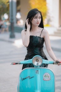 young girl riding a moped