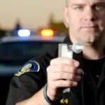 police officer with Breathalyzer