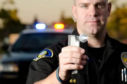 police officer with Breathalyzer