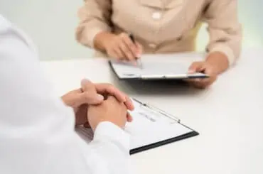 two people doing paperwork