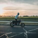 young driver rides a bike before sunset