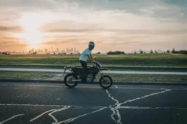 young driver rides a bike before sunset