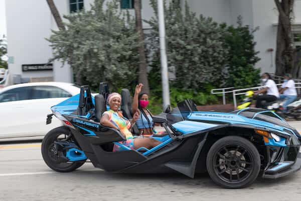 Blue polaris slingshot with driver 3-wheeled motorcycle