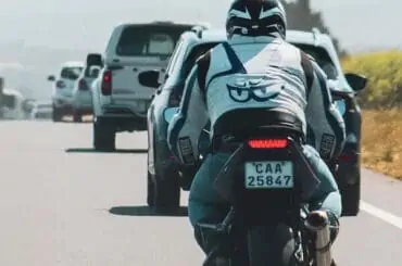 a bike behind cars chasing