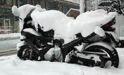 motorcycle covered by ice in winter