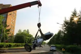 Expected Charges Per Mile When you Take a Motorcycle Towing Service broken bike on road being cleared out