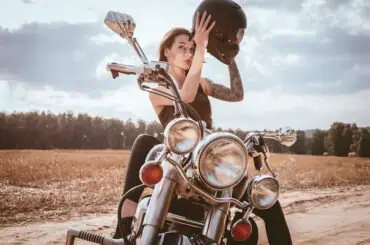 young female biker sitting on a motorcycle