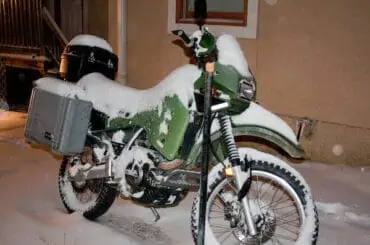 a bike parked outside under snow