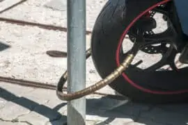 What Insurance Covers Theft of Motorcycle Parts? Rear wheel of powerful motorcycle locked with chain