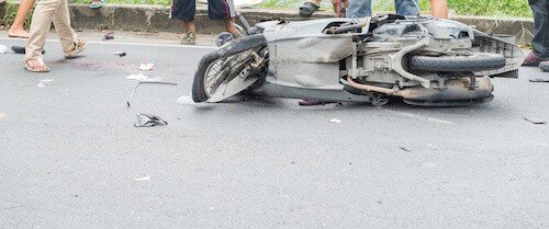 motorcycle falls on road after a severe accident