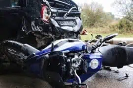 How to Buy Back a Totaled Motorcycle from Your Insurance Company? motorcycle and car crash in road