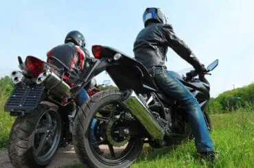 Is It Worth Getting ABS on a Motorcycle? Two motorcyclists standing on country road