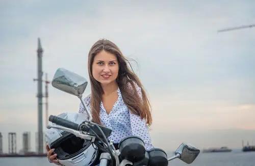girl on a motorcycle while it is parked