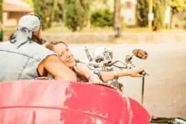 The Thrill of the Ride: Navigating Highways and Freeways in a Slingshot Couple on road with a red trike
