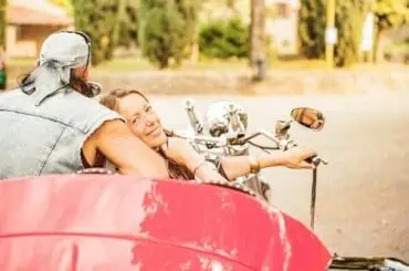 Couple on road with a red trike