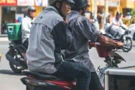 How to Safely Ride a Motorcycle with a Heavy Passenger? passenger is riding on the back of a motorcycle on the road