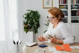 How is Motorcycle Insurance Paid, Monthly or Yearly? Which Payment Option is More Cost-Effective? woman counting money